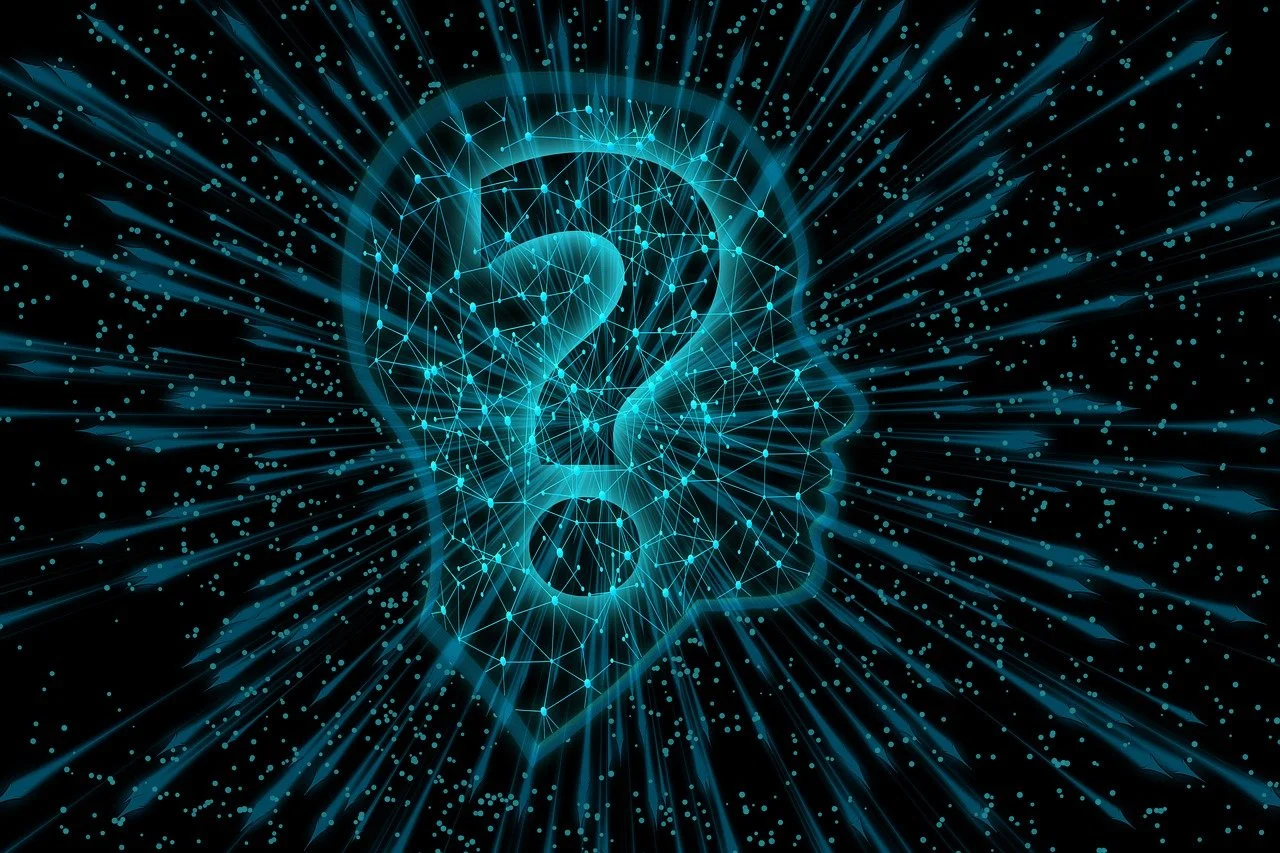 Glowing blue neural network forming a human head silhouette around a question mark, representing artificial intelligence