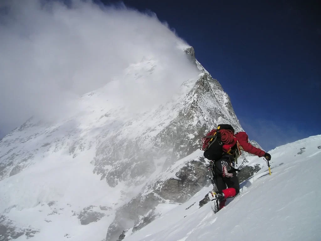 man climbing mountain